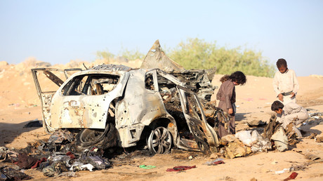 Boys inspect the wreckage of a car hit by a drone air strike in Yemen last year © Ali Owidha