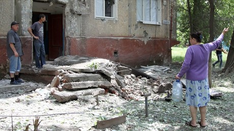 Residents in the courtyard of a residential building hit by shelling in the village of Gorlovka, Donetsk Region © Sergey Averin