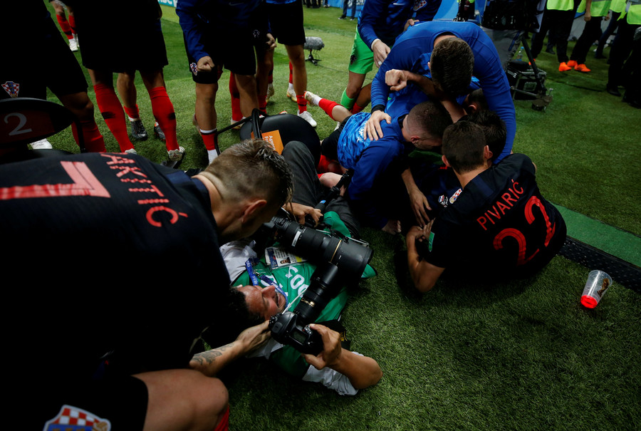 Croatian players send photographer sprawling amid wild World Cup