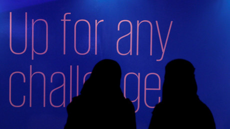 FILE PHOTO. Saudi women walks past an advertisement for Glowork exhibition in Riyadh. © Faisal Nasser