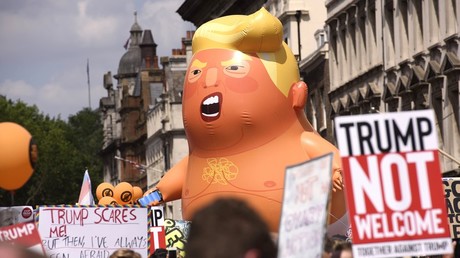 Participants of a protest against US President Donald Trump visiting the UK on the Parliament Square in London © Justin Griffiths-Williams