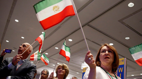 People wave Iranian flags during the playing of the Iranian National Anthem at the 2018 Iran Freedom Convention in Washington, U.S., May 5, 2018. © Joshua Roberts