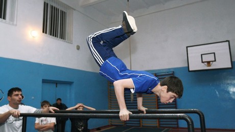 High school students perform complicated stunts on parallel beams at the Street Workout club inside School No. 47 in Grozny © Said Tsarnaev