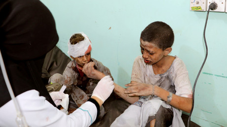 A doctor treats children injured by an airstrike in Saada, Yemen, August 9.