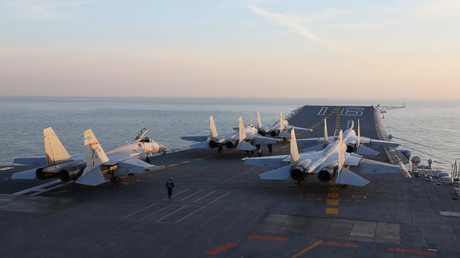 FILE PHOTO: Chinese J-15 fighter jets on the deck of the Liaoning aircraft carrier during military drills. ©  AFP