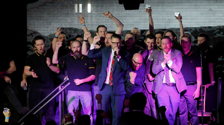 Gavin McInnes speaks on stage with members of the Proud Boys organization. ©  Andrew Kelly