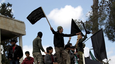 Protesters carry Nusra Front flags during an anti-government protest in the town of Marat Numan in Idlib province, Syria, March 11, 2016. © Khalil Ashawi