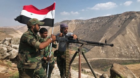 Advancing Syrian troops hoist the national flag. Â© Mikhail Alaeddin