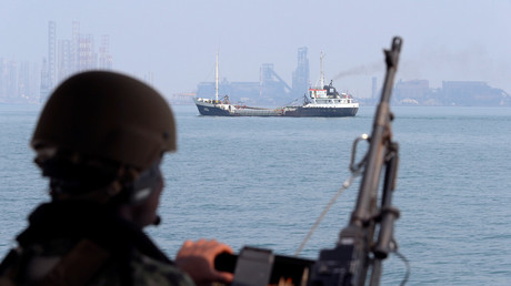 A US Navy soldier onboard Mark VI Patrol Boat stands guard as an oil tanker makes its way towards Bahrain port © Hamad I Mohammed