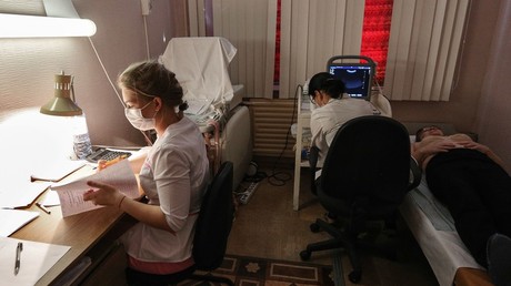 Resident of the Umba village of the Tersky District in the Murmansk Region undergoes  ultrasound exam with the help of a portable device under the Health Train program © Pavel Lvov