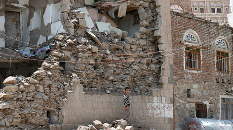 A boy stands next to a house destroyed by an air strike in the old quarter of Sanaa, Yemen. © Reuters / Khaled Abdullah