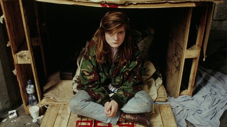 A homeless girl inside her shelter made from crates and cardboard, London, England © Global Look Press /  Peter Arkell