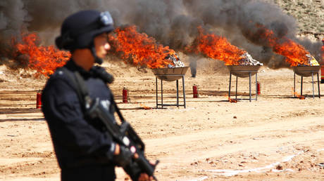 FILE PHOTO: Chinese police burn down confiscated drugs