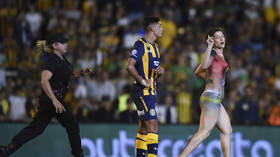 Near-naked female streaker protesting violence in football halts ...