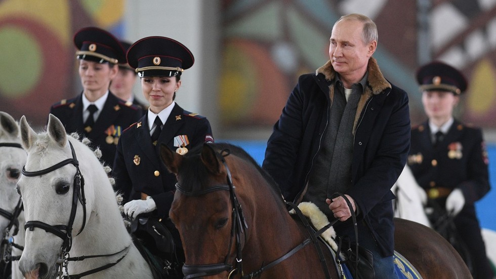 Putin rides horse (this time fully clothed) alongside mounted ...