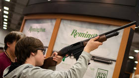 A boy with an Remington firearm at the annual National Rifle Association (NRA) meeting in Dallas, Texas, US, May 4, 2018