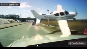 WATCH: Plane scrapes along highway inches from truck before crashing near airport