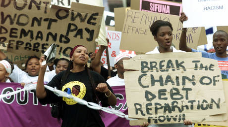Demonstrators protest outside the opening session of the World Conference Against Racism (WCAR), August 31, 2001. © Reuters /Mike Hutchings MH/CLH/ FILE PHOTO