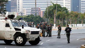 Caracas warns it'll use weapons if needed as crowds of coup supporters flock to presidential palace