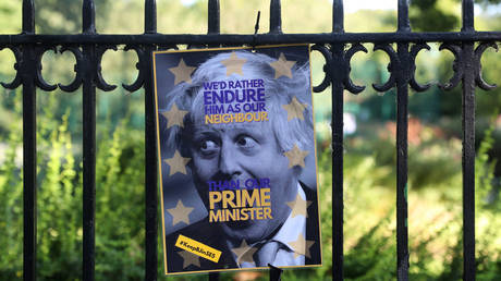 A poster depicting PM hopeful Boris Johnson hangs on a fence of the park opposite his house in London © Reuters / Simon Dawson