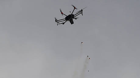 FILE PHOTO: Israeli drone drops tear gas grenades during clashes with Palestinians along the Israel border with Gaza