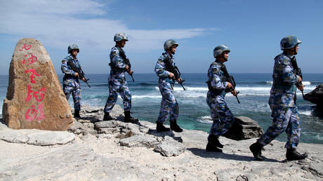 Soldiers of Chinese People's Liberation Army Navy (PLAN) patrol an island in the South China Sea (file photo)