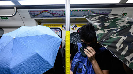 Four ‘uncles’ face off against swarm of armed protesters in Hong Kong metro (VIDEO)