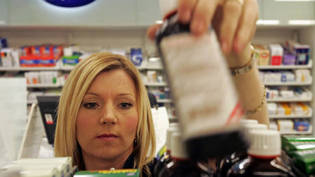 An employee of high street chemists Boots stacks the shelves in the Dalkeith store in Scotland March 14, 2006. © REUTERS/Tony Marsh