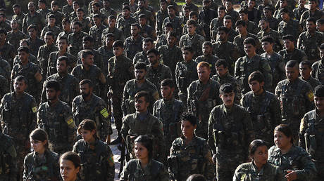 FILE PHOTO Fighters from the Syrian Democratic Forces (SDF), participate in a military parade during the funeral of a fellow fighter, killed during a military mission, in the Kurdish-controlled city of Qamishli in northeastern Syria, on November 11, 2018.
