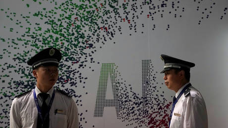 Security officers keep watch in front of an AI (Artificial Intelligence) sign at the annual Huawei Connect event in Shanghai, China. File photo