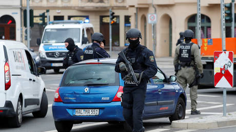Police officers guard near the site of a shooting, in which two people were killed, in Halle, Germany, on October 9, 2019.