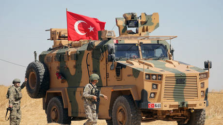 A Turkish soldier walks next to a Turkish military vehicle during a joint U.S.-Turkey patrol, near Tel Abyad, Syria September 8, 2019. © REUTERS/Rodi Said