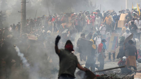 A demonstrator throws a tear gas canister during a protest against Ecuador's President Lenin Moreno's austerity measures in Quito, Ecuador. October 12, 2019.