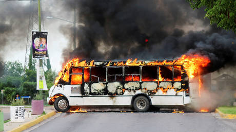 A burning bus, set alight by cartel gunmen to block a road, is pictured during clashes with federal forces following the detention of Ovidio Guzman, son of drug kingpin Joaquin "El Chapo" Guzman, in Culiacan, Sinaloa state, Mexico October 17, 2019