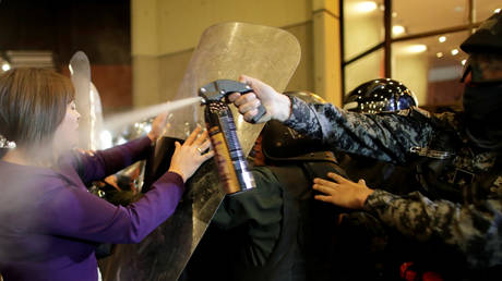 Riot police use pepper spray on demonstrators during a protest in La Paz, Bolivia, October 21, 2019.