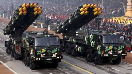 Indian army officers stand on vehicles displaying missiles during the Republic Day parade in New Delhi