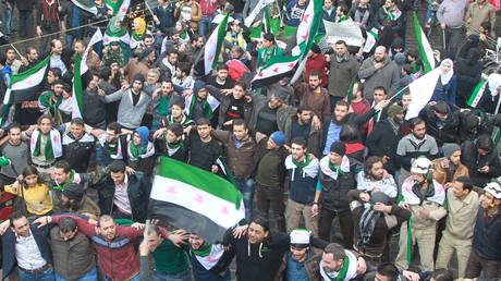 "White Helmets" (bottom right) and Islamist militants celebrating together in Aleppo, Syria, March 15, 2016.