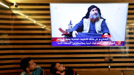 FILE PHOTO: Iraqi youth watch the news of Islamic State leader Abu Bakr al-Baghdadi death, in Najaf, Iraq October 27, 2019