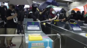 Masked Hong Kong protesters SMASH UP metro station with metal bars and hammers in defiance of emergency order (VIDEO)