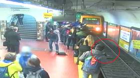WATCH: Buenos Aires commuters stage frantic rescue after woman KNOCKED onto metro tracks (VIDEO)