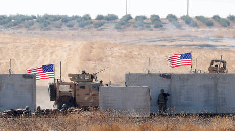 FILE PHOTO: US troops seen behind Turkish border walls during a joint US-Turkey patrol in northern Syria © Reuters / Murad Sezer