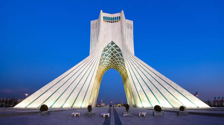 Azadi Tower illuminated at late dusk in Tehran, Iran