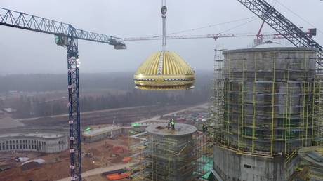 Got it covered: 34-ton titanium-decorated dome placed on top of Russia's grand MILITARY CATHEDRAL