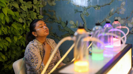 A customer inhales oxygen mixed with aromatherapy at an oxygen bar in New Delhi, India, November 15, 2019.