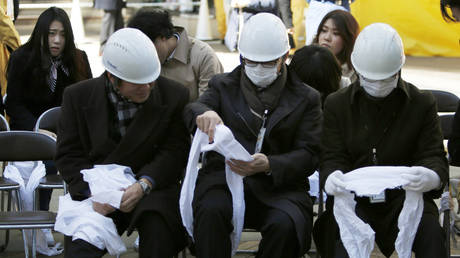 Safety first: Japanese MPs practice putting on foldable helmets in earthquake drill (VIDEO)