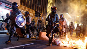 Tear gas, water cannons, fuel bombs & barricades as protesters clash with police in Hong Kong