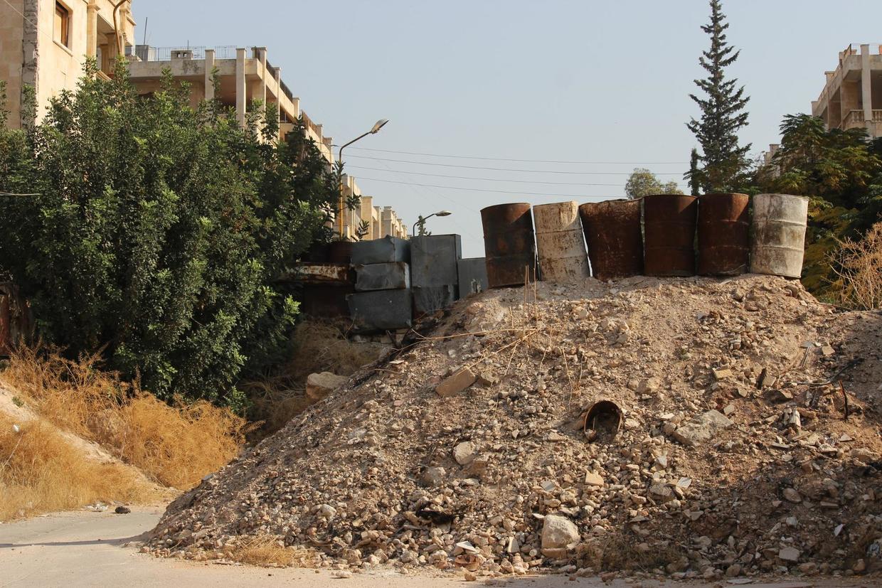 Rudimentary protection against sniper fire at the end of a residential street in Al Zahraa, west Aleppo. ©  Vanessa Beeley