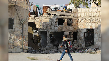 A child walks past an area that has been targeted by the terrorist groups less than 200 meters away. Khalidiyah, west Aleppo. © Vanessa Beeley