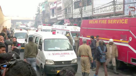 Ambulances and a firefighting vehicle at the scene of a deadly fire that swept through a New Delhi factory © ANI/via REUTERS