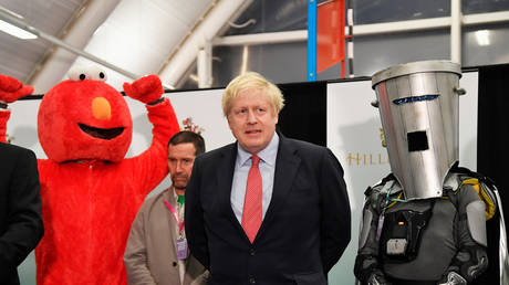 Conservative British PM Boris Johnson looks on during his victory speech alongside costumed "challengers" in Uxbridge, Britain, December 13, 2019.